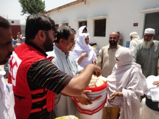 Moin Khan PRCS distributing aid to people affected by floods